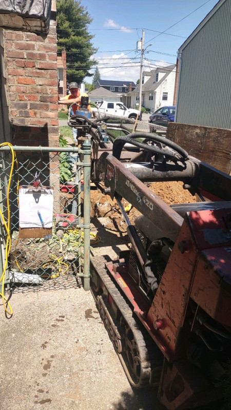 A Helical Pier Being Installed by Zavza Seal's Helical Pier Installation Technician and Monitored by Jake Kamin