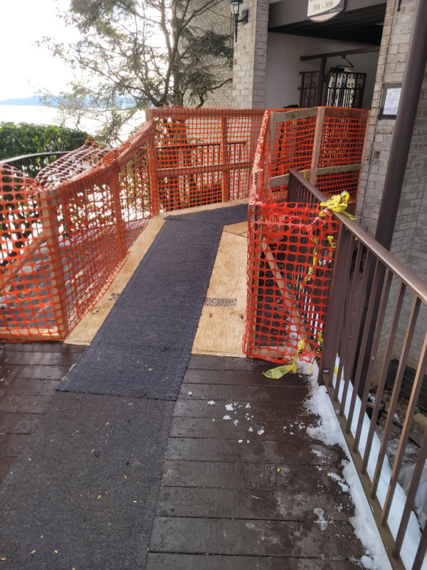 Temporary safety-fenced access route keeping residents moving during construction